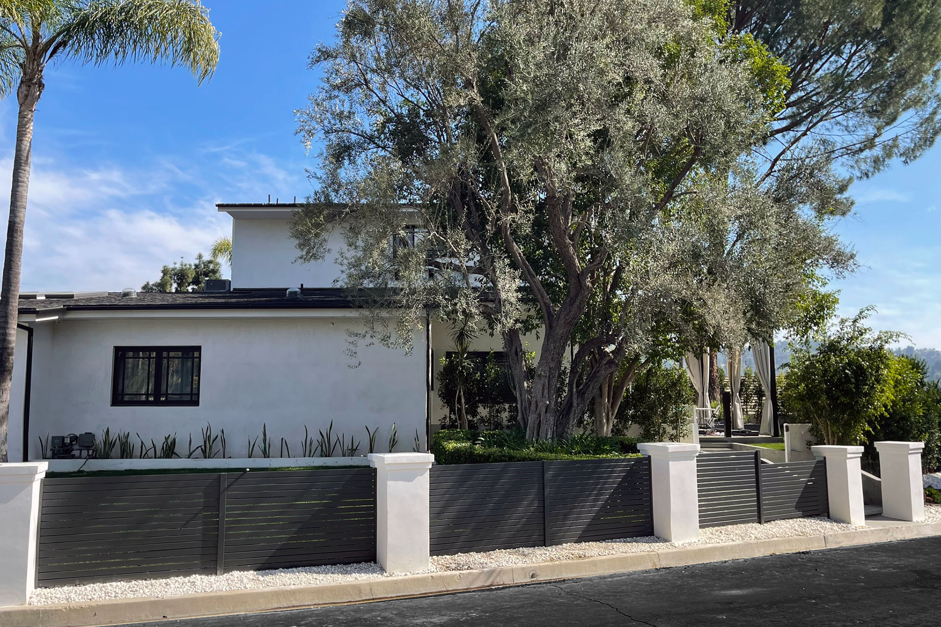 Modern black horizontal aluminum slat fence at a California home